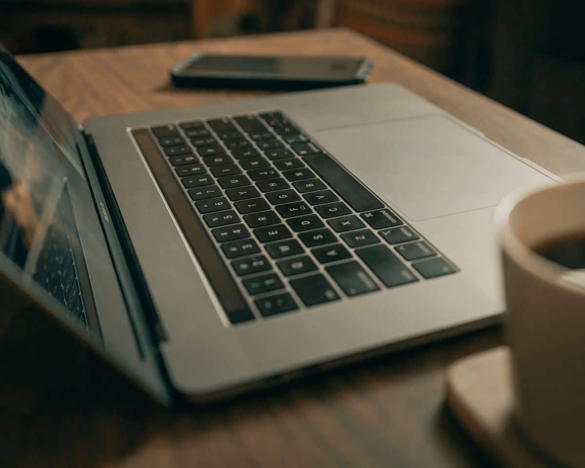 macbook pro on brown wooden table