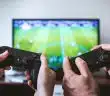 two people playing Sony PS4 game console